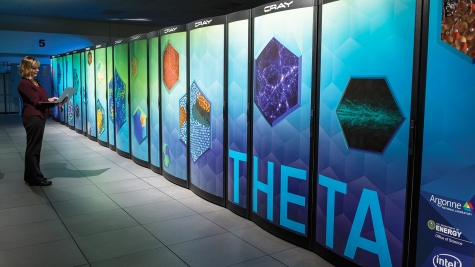 A woman stands next to Theta