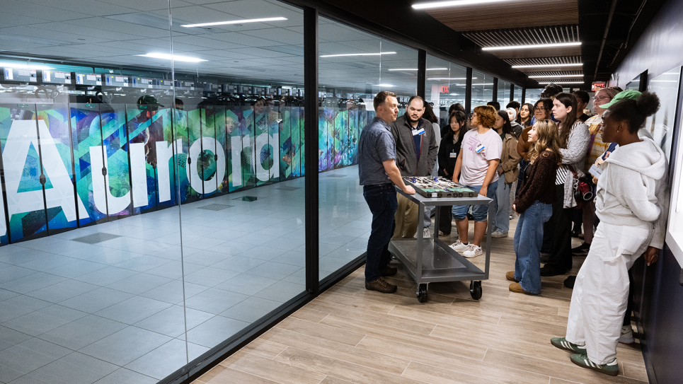 Image of students by Aurora during a tour of the lab.